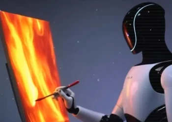 روبوت تسلا Optimus يرسم لوحة فنية باستخدام فرشاة، مما يعكس تطور الروبوتات البشرية الذكية وقدرتها على أداء المهام الإبداعية إلى جانب الوظائف التقليدية.