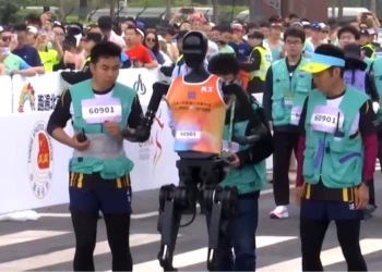 روبوتات بشرية تركض بجانب عدائين بشر خلال سباق نصف ماراثون في بكين