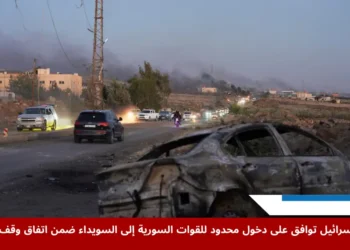 تصاعد الدخان في أحد شوارع محافظة السويداء حيث تظهر سيارة مدمرة وسط آثار الاشتباكات العنيفة بين مقاتلين بدو وفصائل درزية، قبل إعلان وقف إطلاق النار